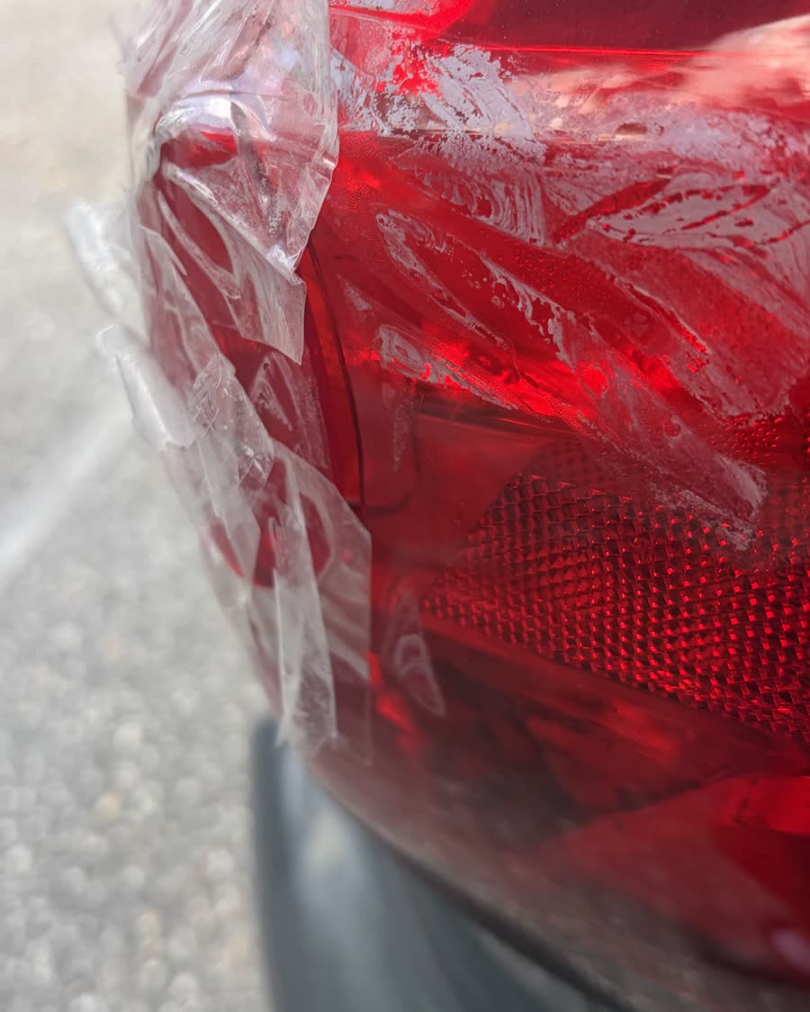 Cracked taillight held together with tape, before repair